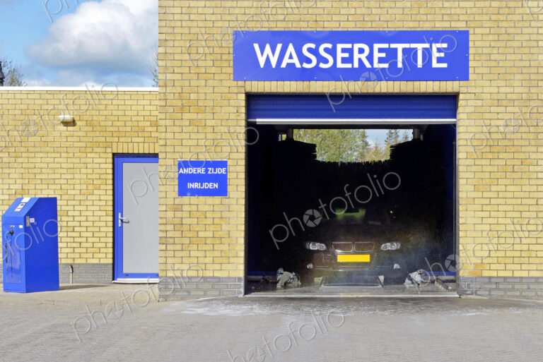 An automated car wash in operation with open door.