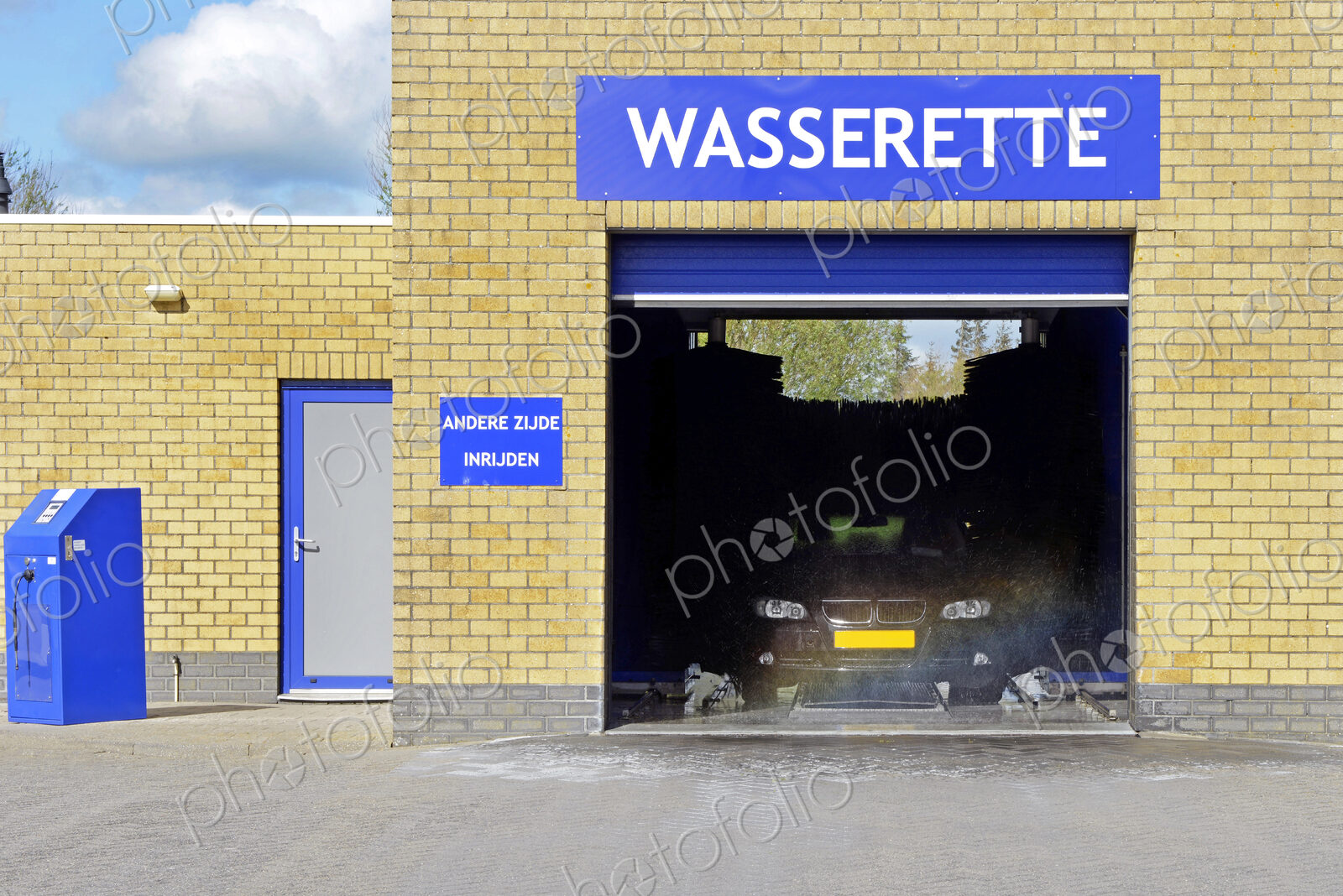 An automated car wash in operation with open door.