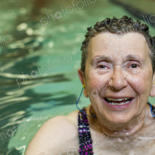 An elderly woman in a swimming pool.