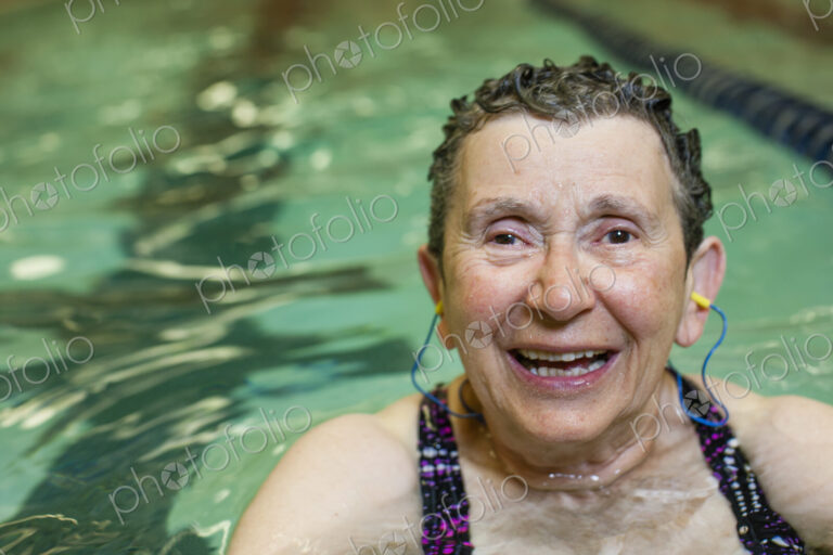 An elderly woman in a swimming pool.