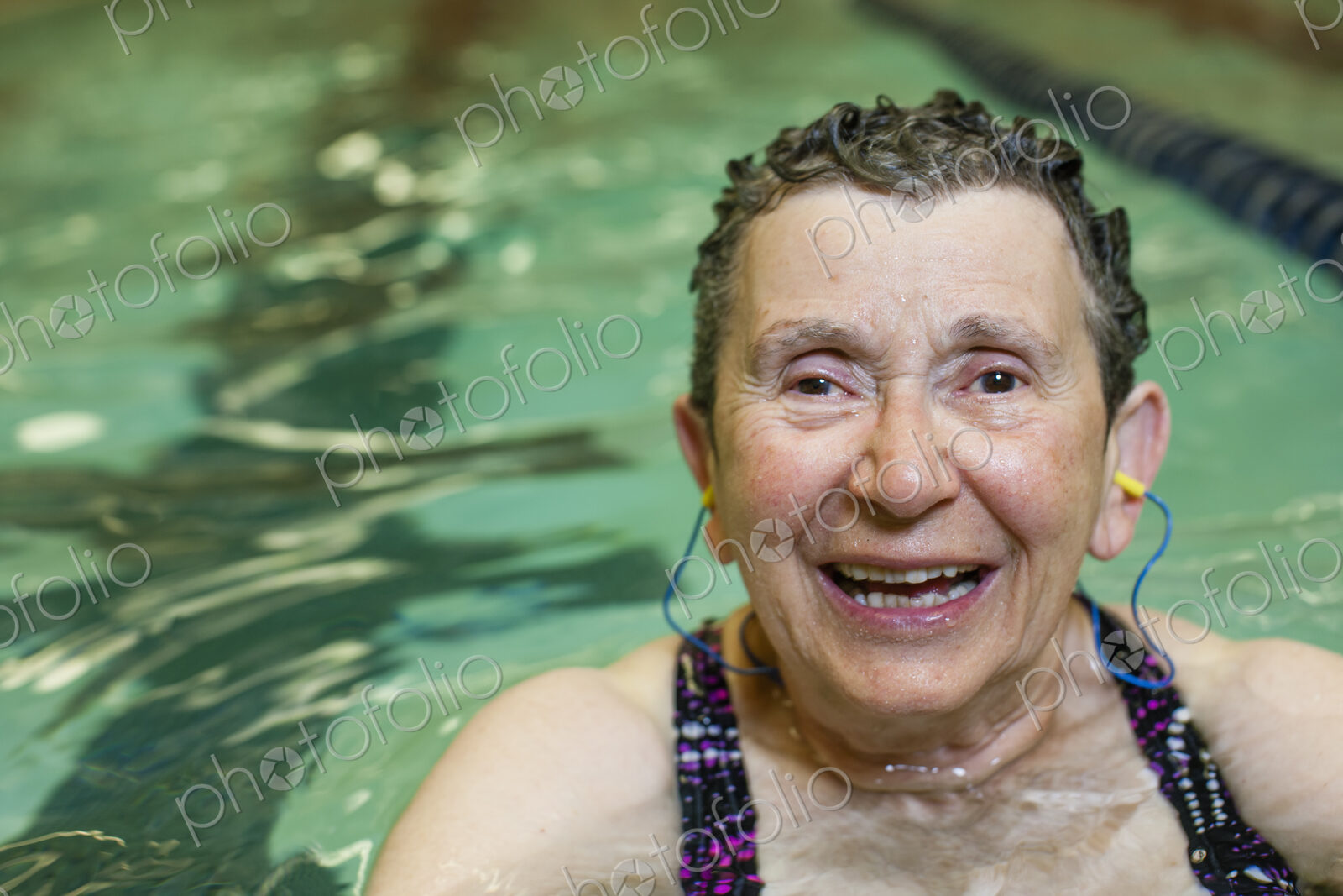 An elderly woman in a swimming pool.