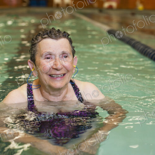 An elderly woman in a swimming pool. An elderly woman in a swimming pool.