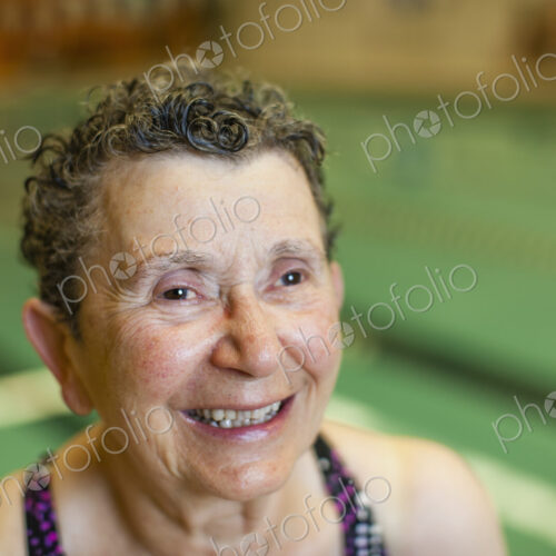 An elderly woman in a swimming pool. An elderly woman in a swimming pool.