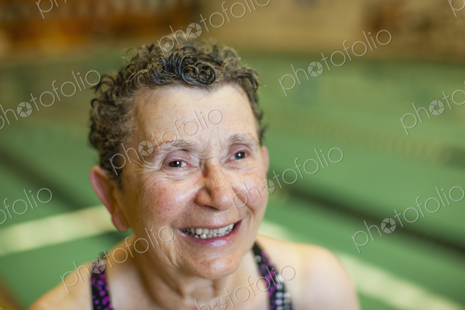 An elderly woman in a swimming pool.