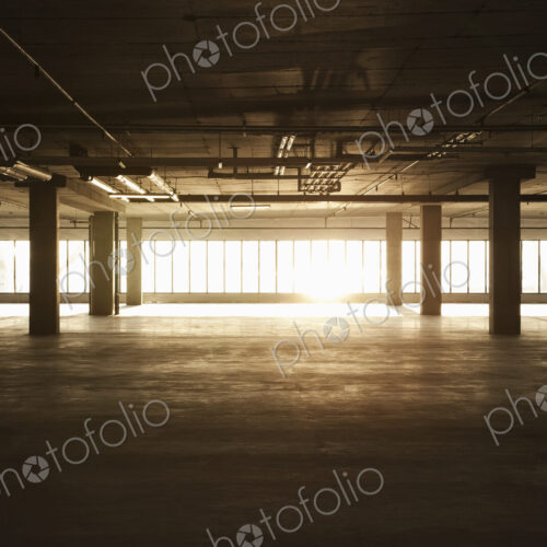 An empty raw business space ready for occupancy. Low light coming in the windows, lens…