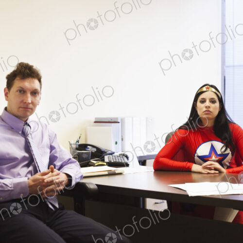 An hispanic businesswoman office super hero and her caucasian male team member in her… An hispanic businesswoman office super hero and her caucasian male team member in her…
