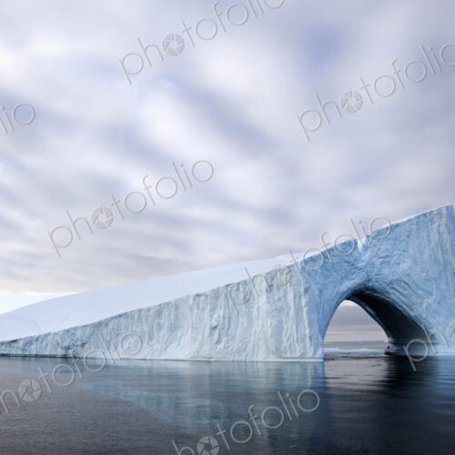 An iceberg on the water of Baffin Bay, with a natural arch. An iceberg on the water of Baffin Bay, with a natural arch.