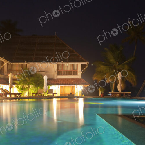 An infinity pool at night, on the terrace of a luxury hotel in Alleppey, Kerala India. An infinity pool at night, on the terrace of a luxury hotel in Alleppey, Kerala India.