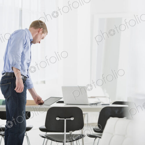 An office in the city. Business. A man checking something on his desk. An office in the city. Business. A man checking something on his desk.