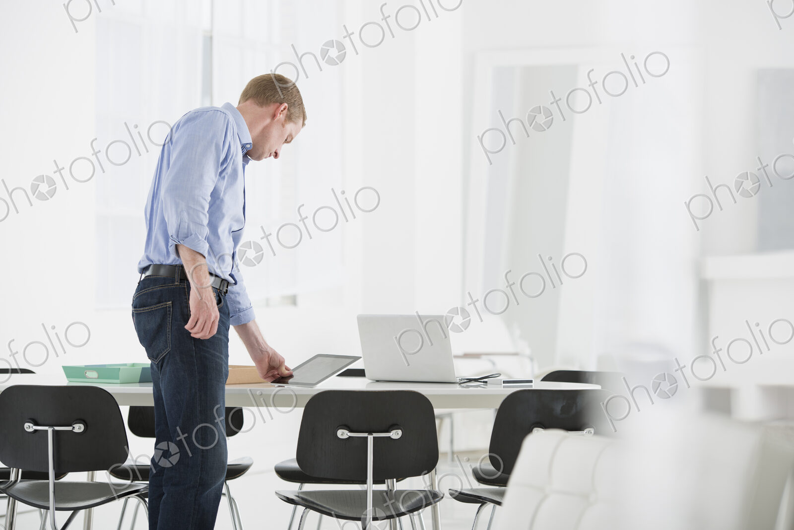 An office in the city. Business. A man checking something on his desk.