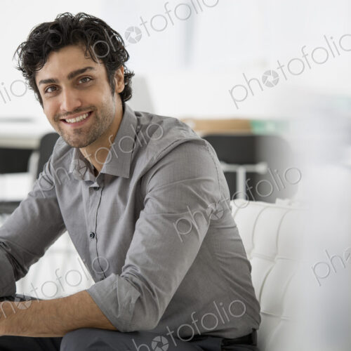 An office in the city. Business. A man seated with his hands clasped in a relaxed… An office in the city. Business. A man seated with his hands clasped in a relaxed…