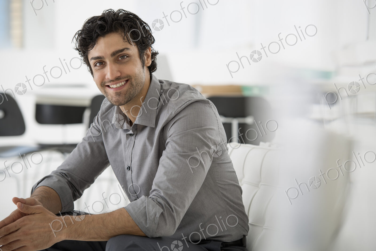 An office in the city. Business. A man seated with his hands clasped in a relaxed…