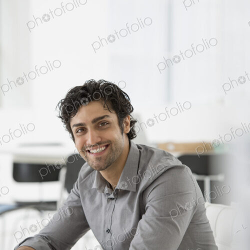 An office in the city. Business. A man seated with his hands clasped in a relaxed… An office in the city. Business. A man seated with his hands clasped in a relaxed…