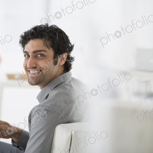 An office in the city. Business. A man sitting holding a book in his hands. Turning… An office in the city. Business. A man sitting holding a book in his hands. Turning…