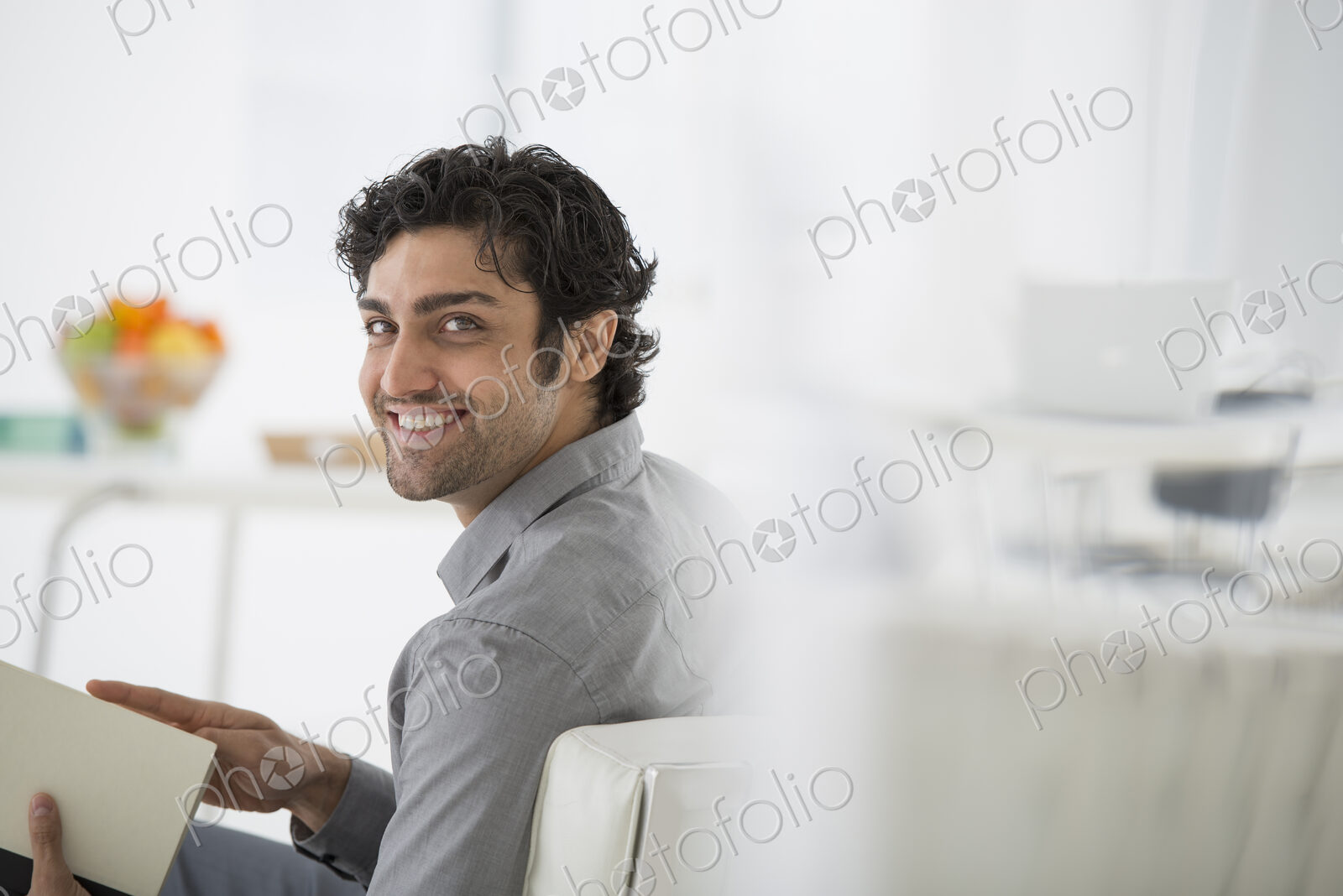 An office in the city. Business. A man sitting holding a book in his hands. Turning…