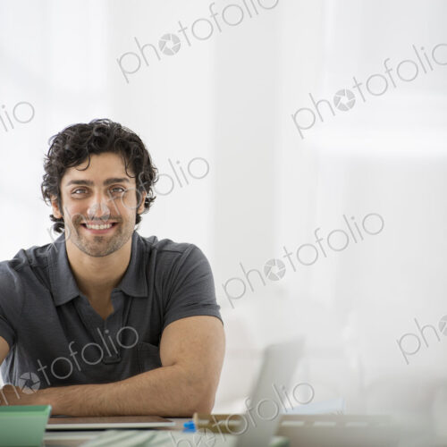 An office in the city. Business. A man sitting in a relaxed pose behind a desk. An office in the city. Business. A man sitting in a relaxed pose behind a desk.