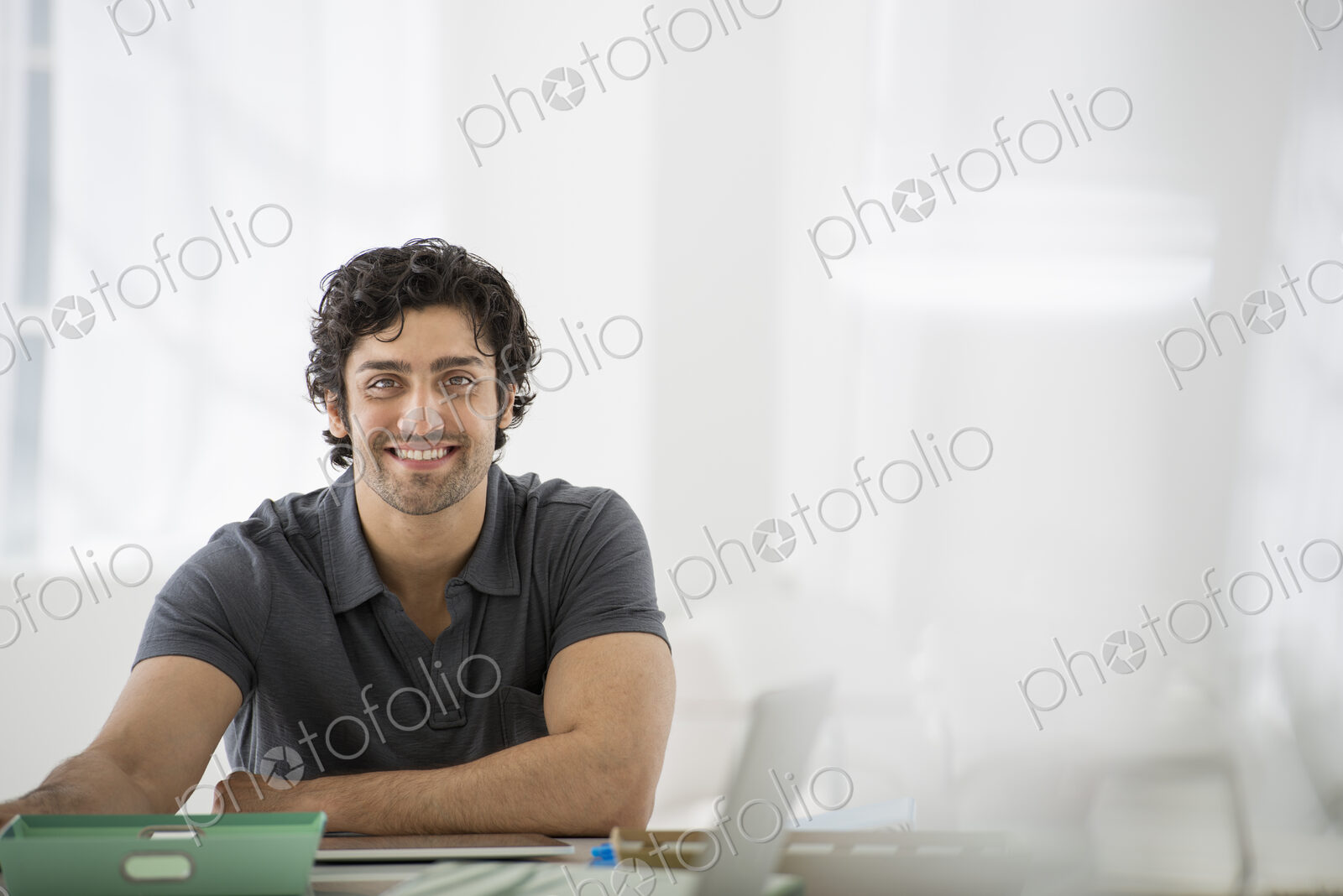 An office in the city. Business. A man sitting in a relaxed pose behind a desk.