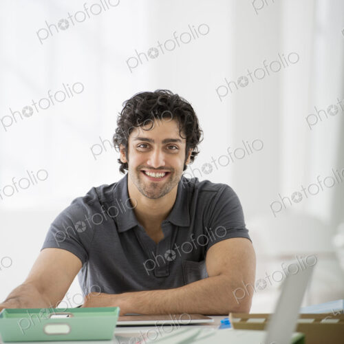 An office in the city. Business. A man sitting in a relaxed pose behind a desk. An office in the city. Business. A man sitting in a relaxed pose behind a desk.
