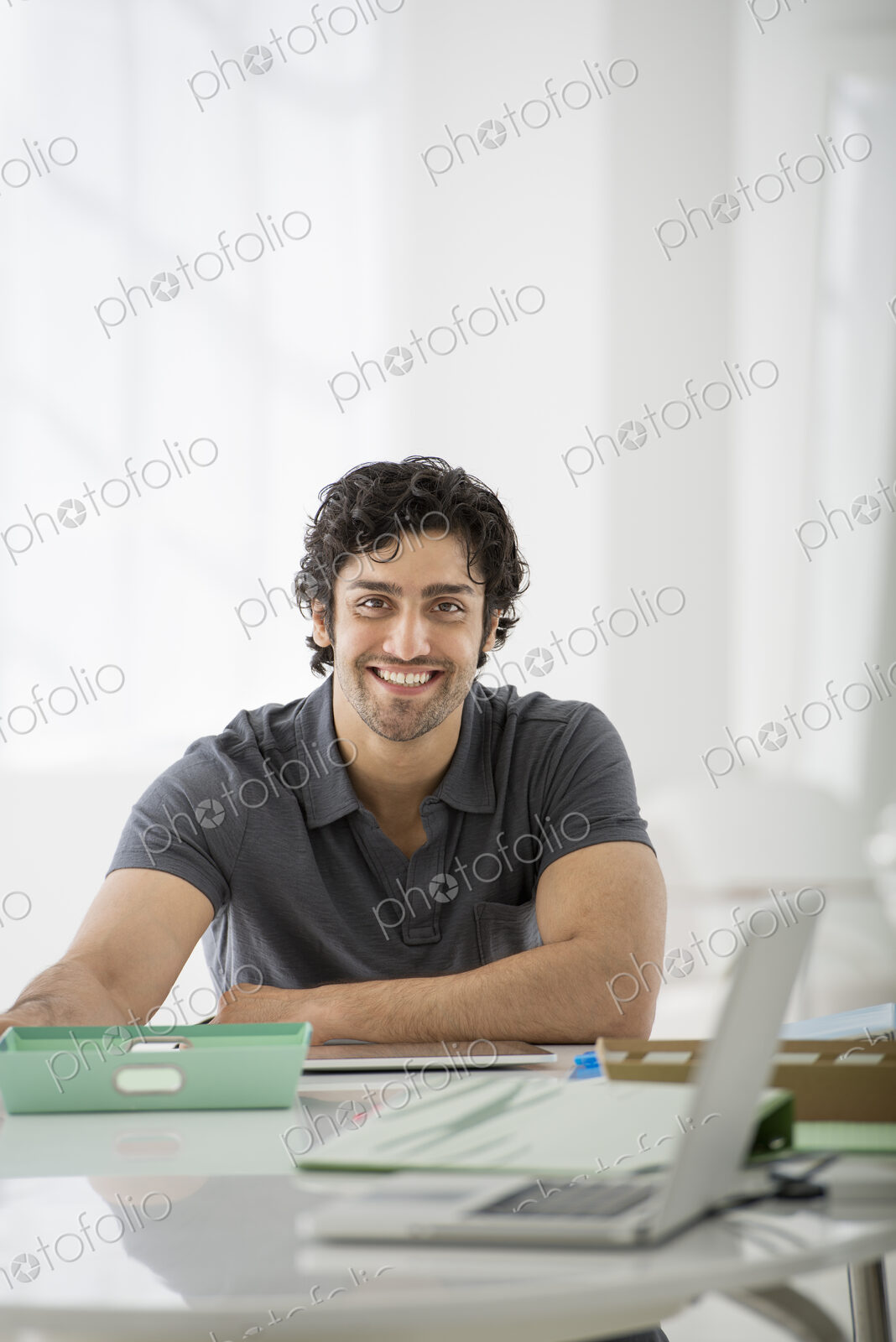 An office in the city. Business. A man sitting in a relaxed pose behind a desk.