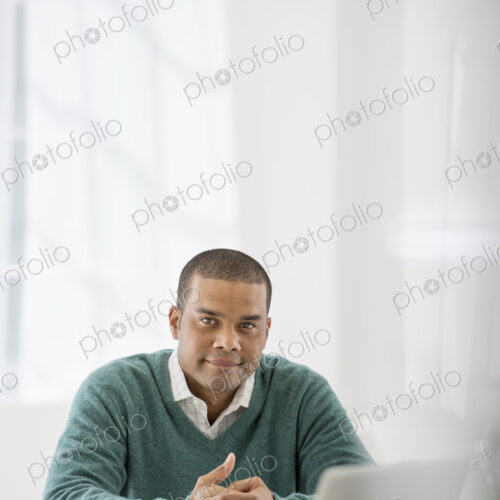 An office in the city. Business. A man sitting with his hands clasped behind a desk. An office in the city. Business. A man sitting with his hands clasped behind a desk.