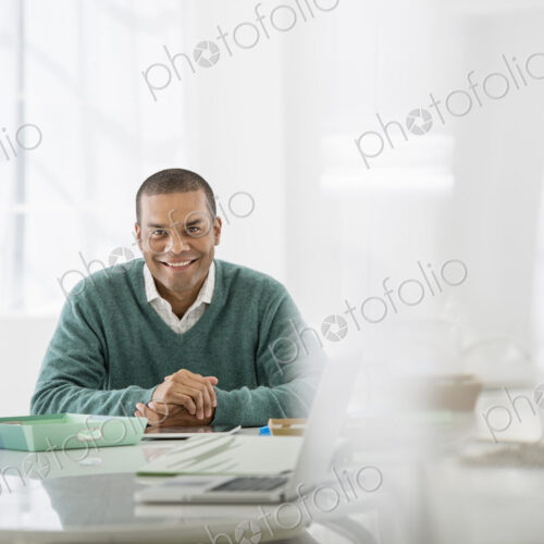 An office in the city. Business. A man sitting with his hands clasped behind a desk. An office in the city. Business. A man sitting with his hands clasped behind a desk.
