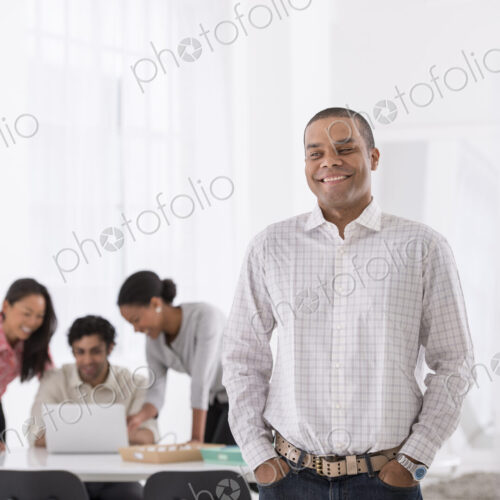 An office in the city. Business. A man standing with his hands in his pockets, and…