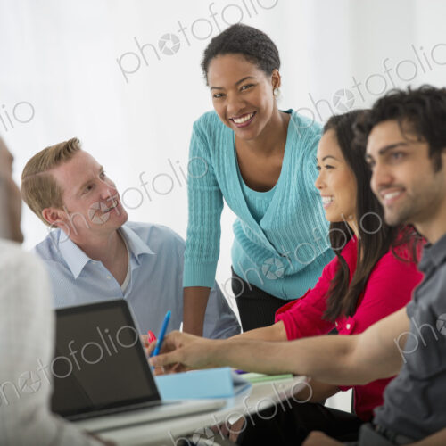 An office in the city. Business. A multi ethnic group of people around a table, men…