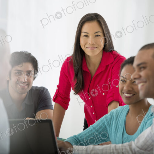 An office in the city. Business. A multi ethnic group of people around a table, men…