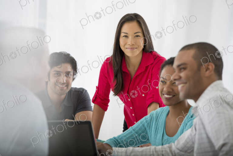 An office in the city. Business. A multi ethnic group of people around a table, men…