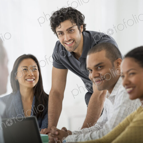 An office in the city. Business. A multi ethnic group of people around a table, men…