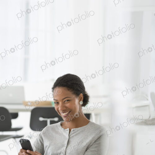An office in the city. Business. A woman seated in a comfortable chair, checking her…
