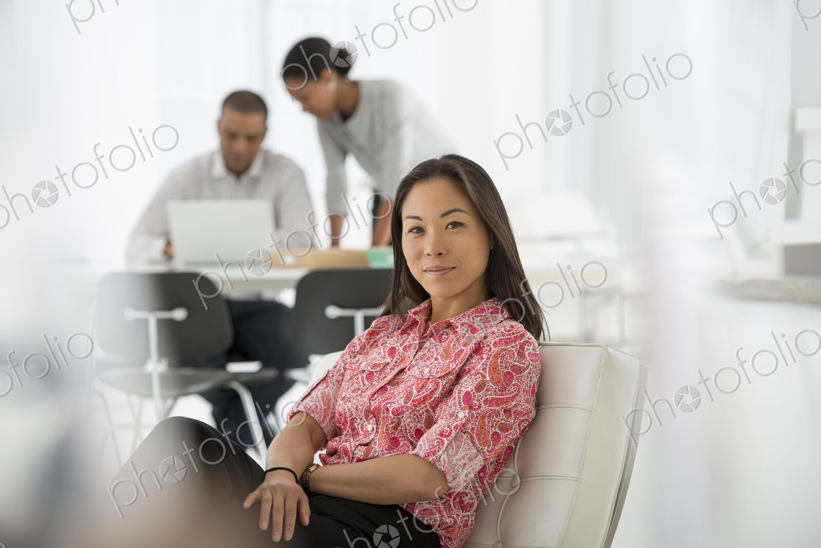 An office in the city. Business. A woman seated on the sofa looking relaxed. Two…