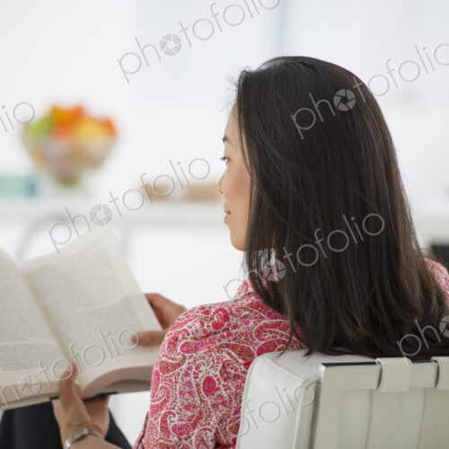 An office in the city. Business. A woman sitting and reading a book. Research or… An office in the city. Business. A woman sitting and reading a book. Research or…