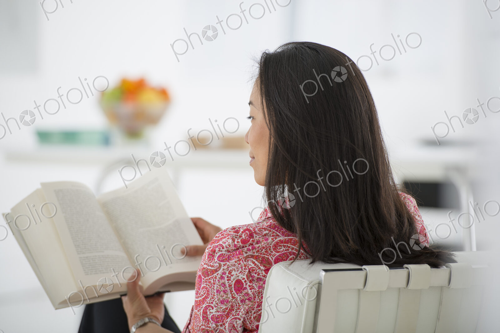 An office in the city. Business. A woman sitting and reading a book. Research or…