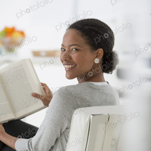 An office in the city. Business. A woman sitting and reading a book. Research or…