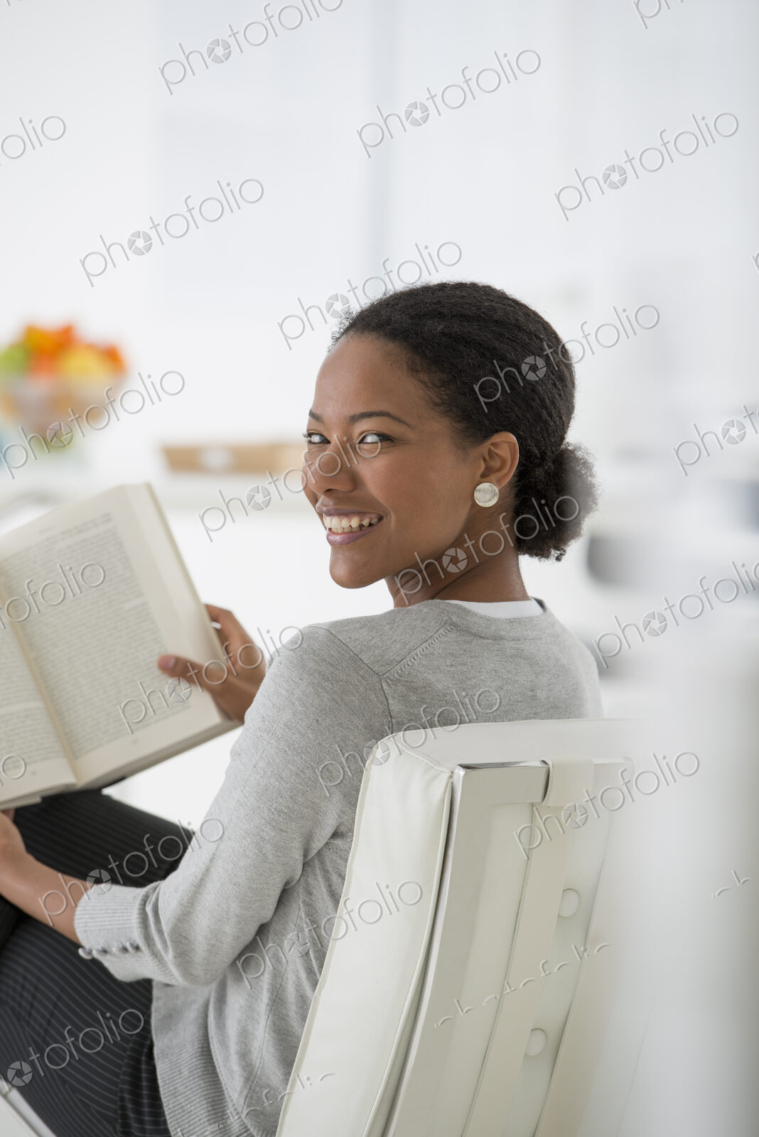 An office in the city. Business. A woman sitting and reading a book. Research or…