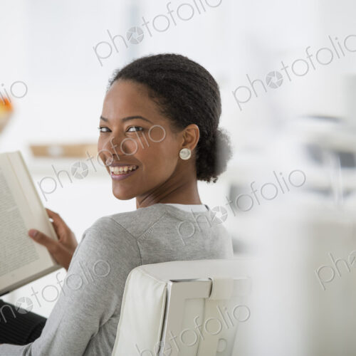 An office in the city. Business. A woman sitting and reading a book. Research or…