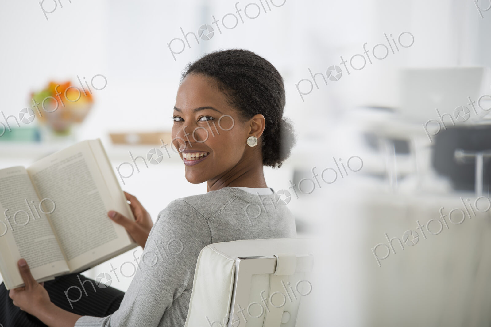 An office in the city. Business. A woman sitting and reading a book. Research or…