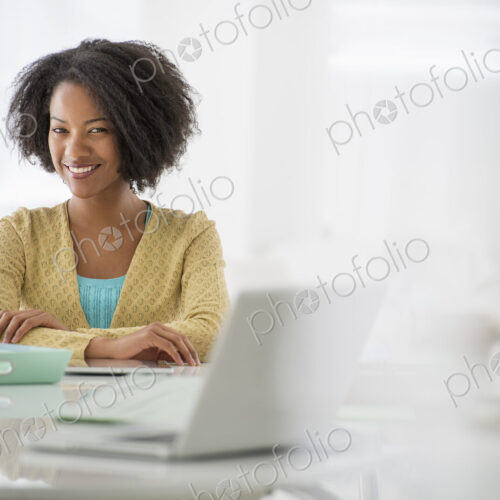 An office in the city. Business. A woman sitting at a desk. Digital tablet and laptop,…