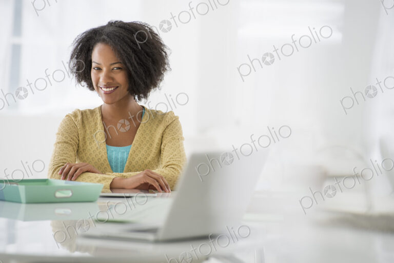 An office in the city. Business. A woman sitting at a desk. Digital tablet and laptop,…