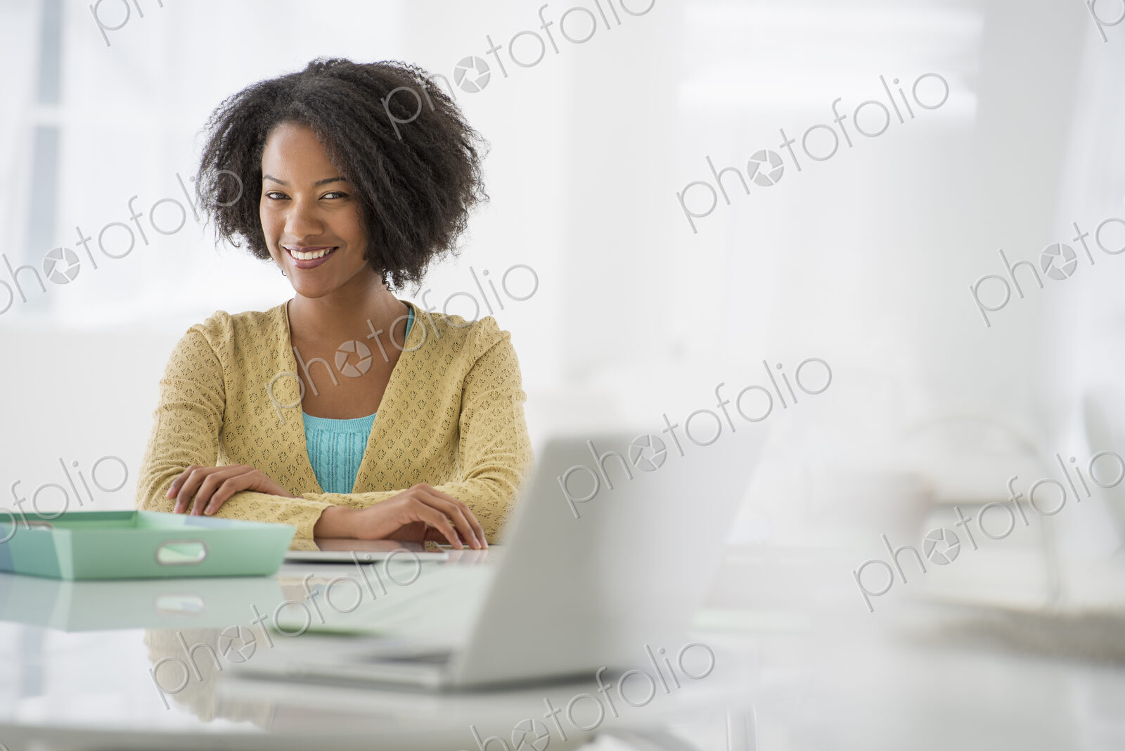 An office in the city. Business. A woman sitting at a desk. Digital tablet and laptop,…