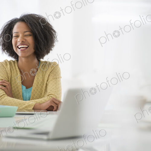 An office in the city. Business. A woman sitting at a desk. Digital tablet and laptop,…