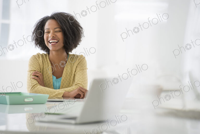 An office in the city. Business. A woman sitting at a desk. Digital tablet and laptop,…