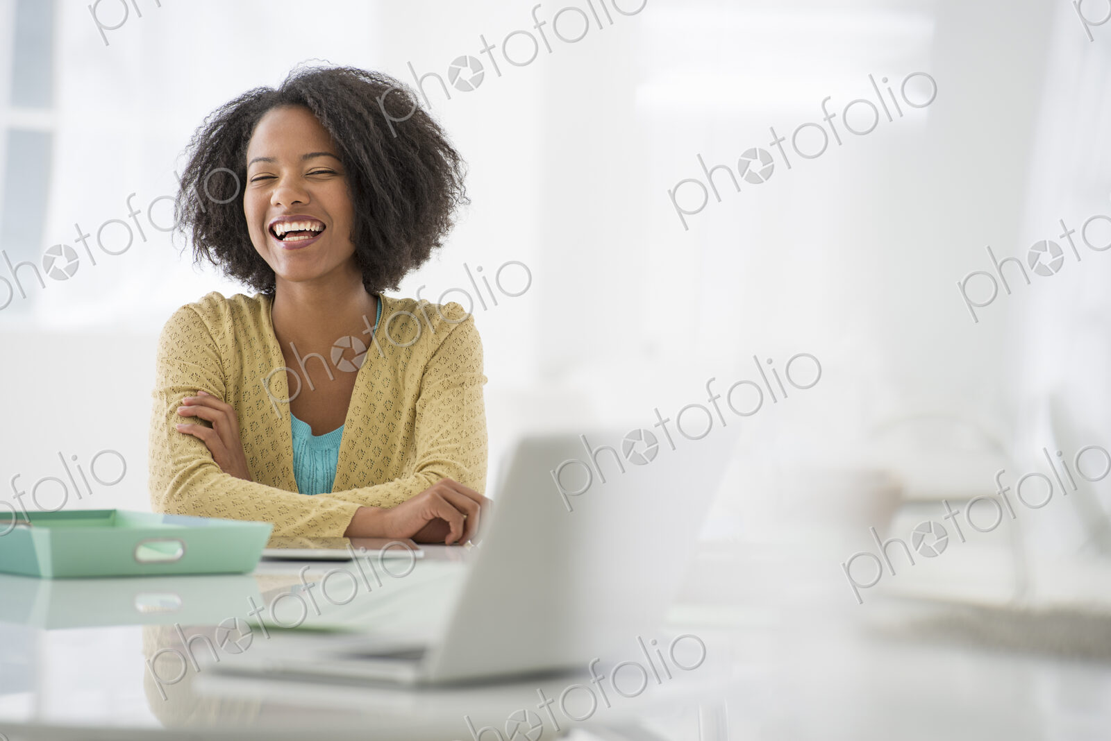 An office in the city. Business. A woman sitting at a desk. Digital tablet and laptop,…