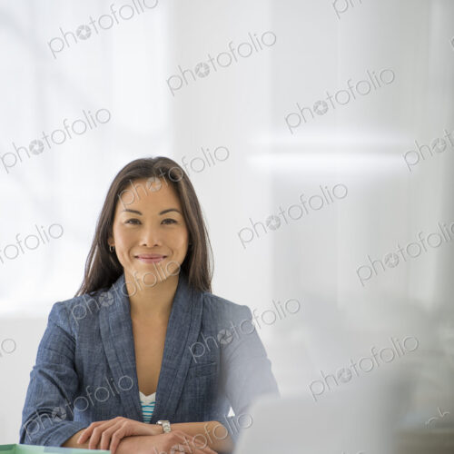 An office in the city. Business. A woman sitting at a desk. Digital tablet and laptop,… An office in the city. Business. A woman sitting at a desk. Digital tablet and laptop,…