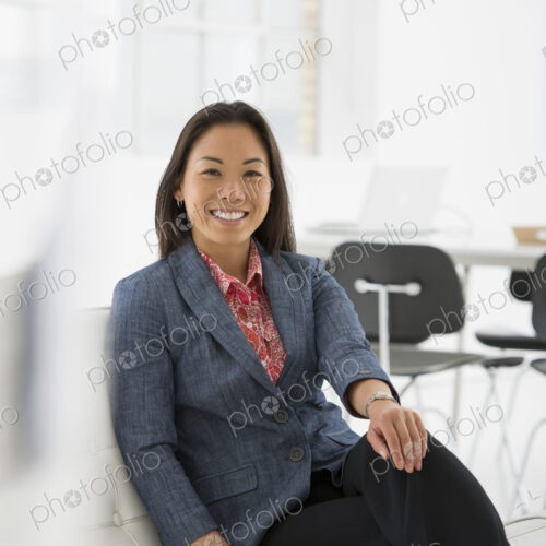 An office in the city. Business. A woman sitting relaxing on a comfortable chair. An office in the city. Business. A woman sitting relaxing on a comfortable chair.