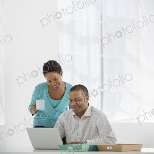 An office in the city. Business. A woman with a cup of coffee and a man looking at a…