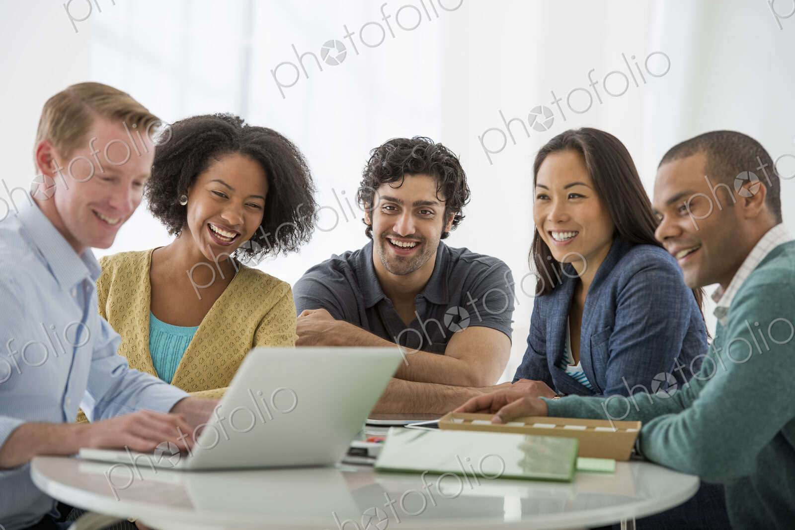An office in the city. Business. Team meetings. A group sitting down around a table.…