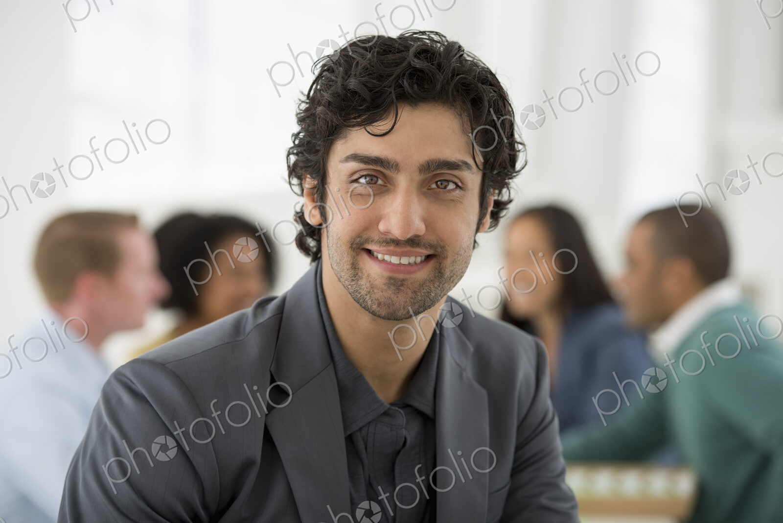 An office in the city. Business. Team meetings. A group sitting down around a table.…