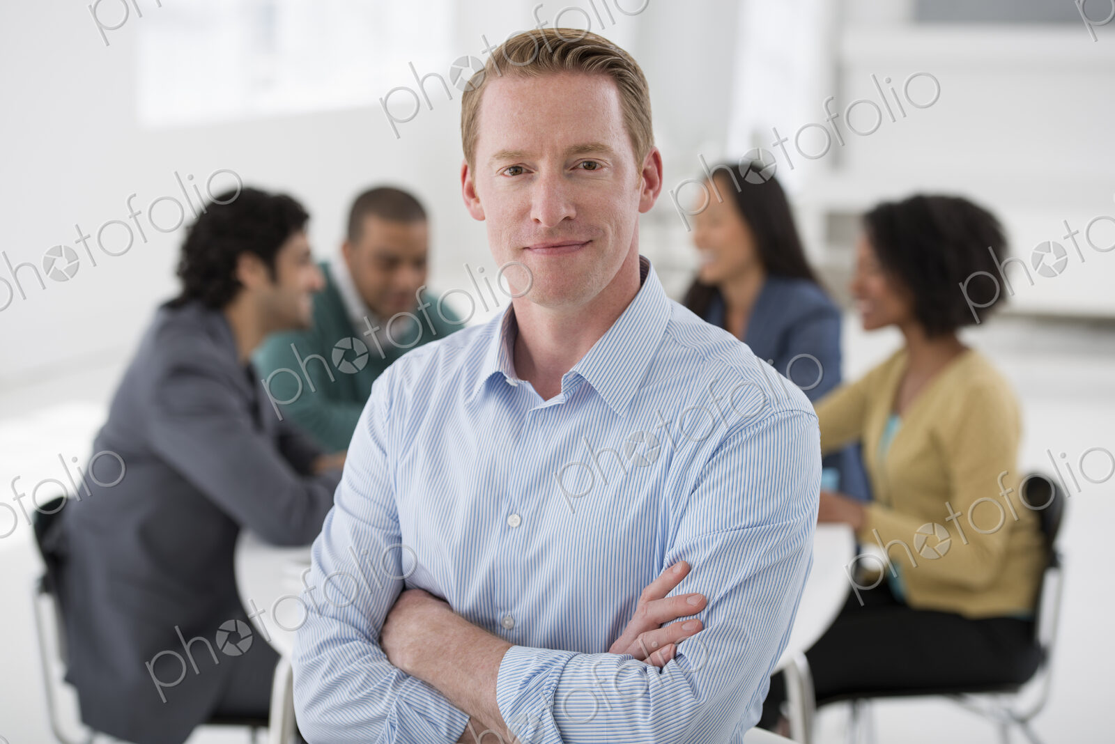 An office in the city. Business. Team meetings. A group sitting down around a table.…